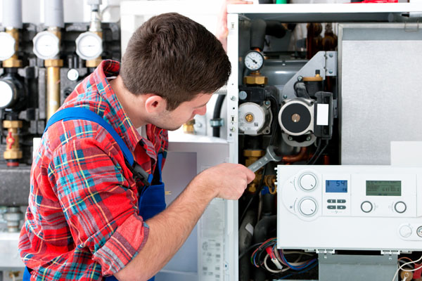 HVAC technician inspecting an indoor heating system in Marana, AZ