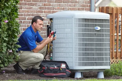 HVAC technician inspecting an outdoor air conditioning unit in Marana, AZ